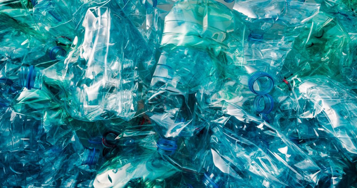 Crushed plastic bottles heap ready for recycling